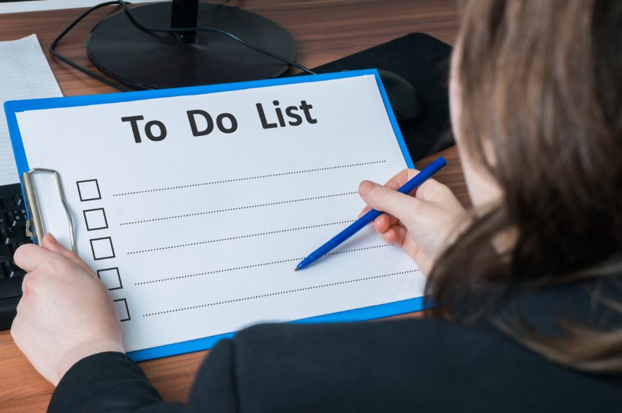 A woman holding a to-do list