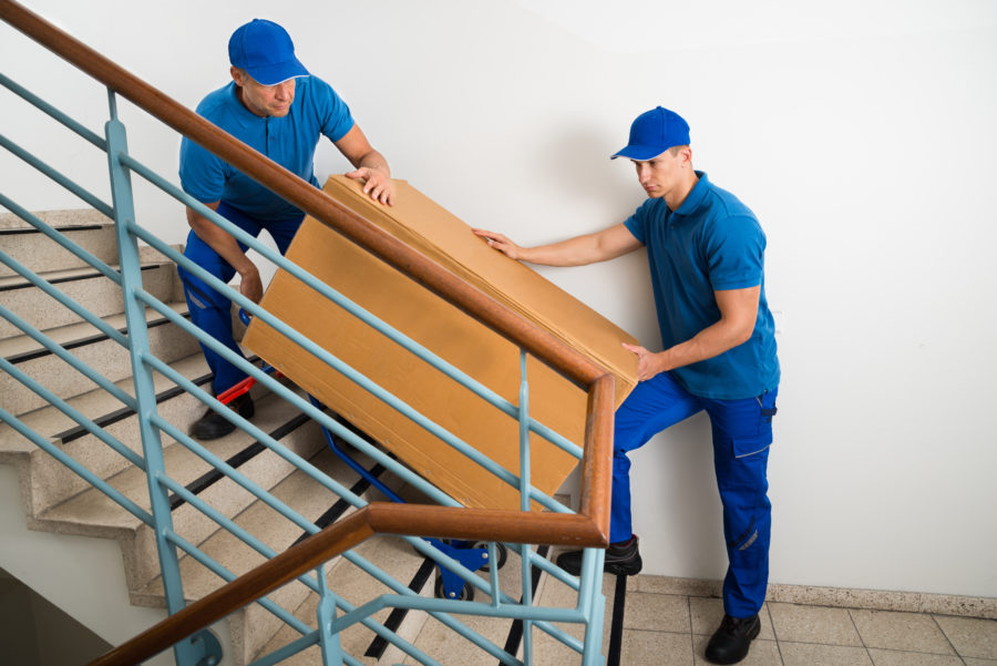 Men carrying sofa down the stairs. 